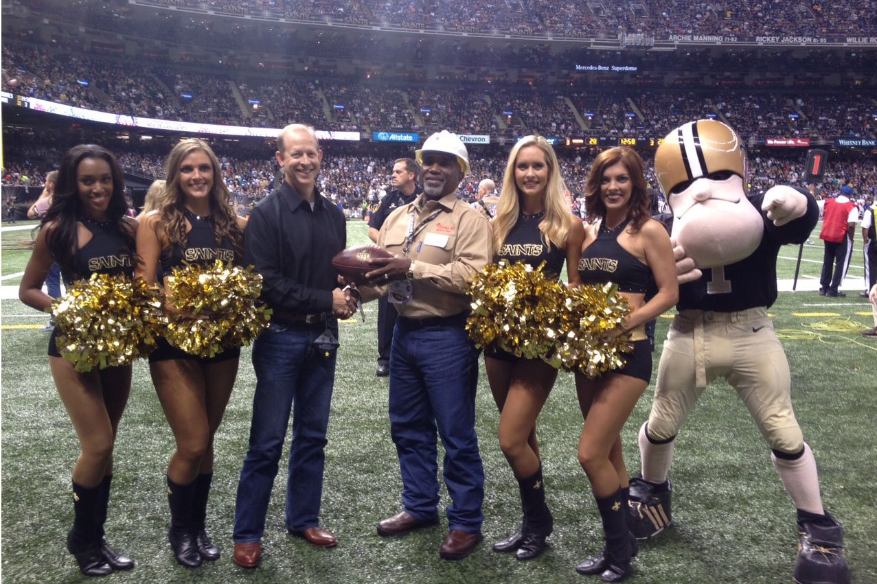 Sir Saint and the Saintsations join Entergy Mississippi's Darron Case in congratulating Ray Vaughn, Lineman of the Game, for the Nov. 1 Saints-Giants game at the Superdome.